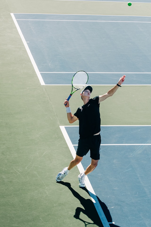 Tennis instructor providing personalized coaching to student, demonstrating the importance of lessons in skill development