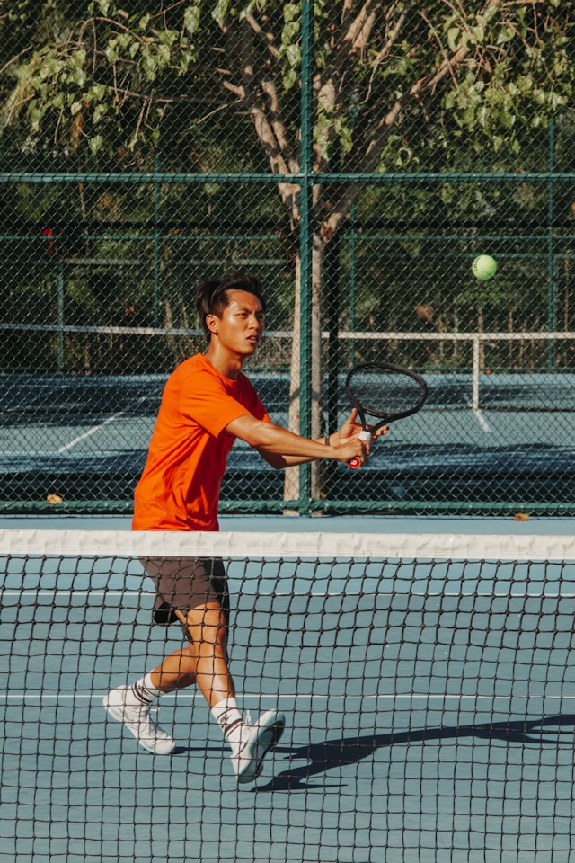 Senior tennis players actively competing on court, demonstrating the lifelong health benefits and vitality that tennis provides